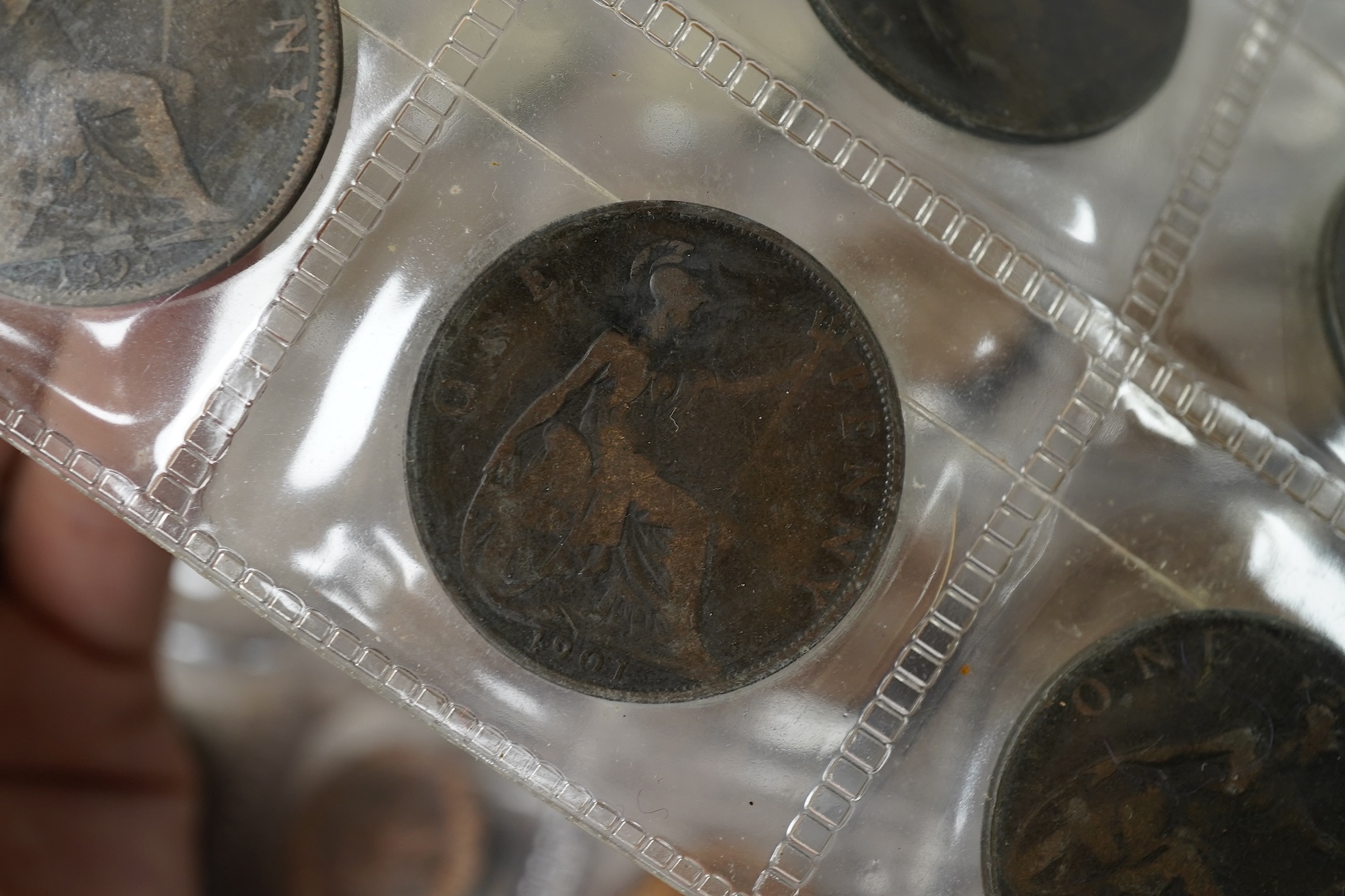 A collection of various coinage in an album, mostly George V to QEII